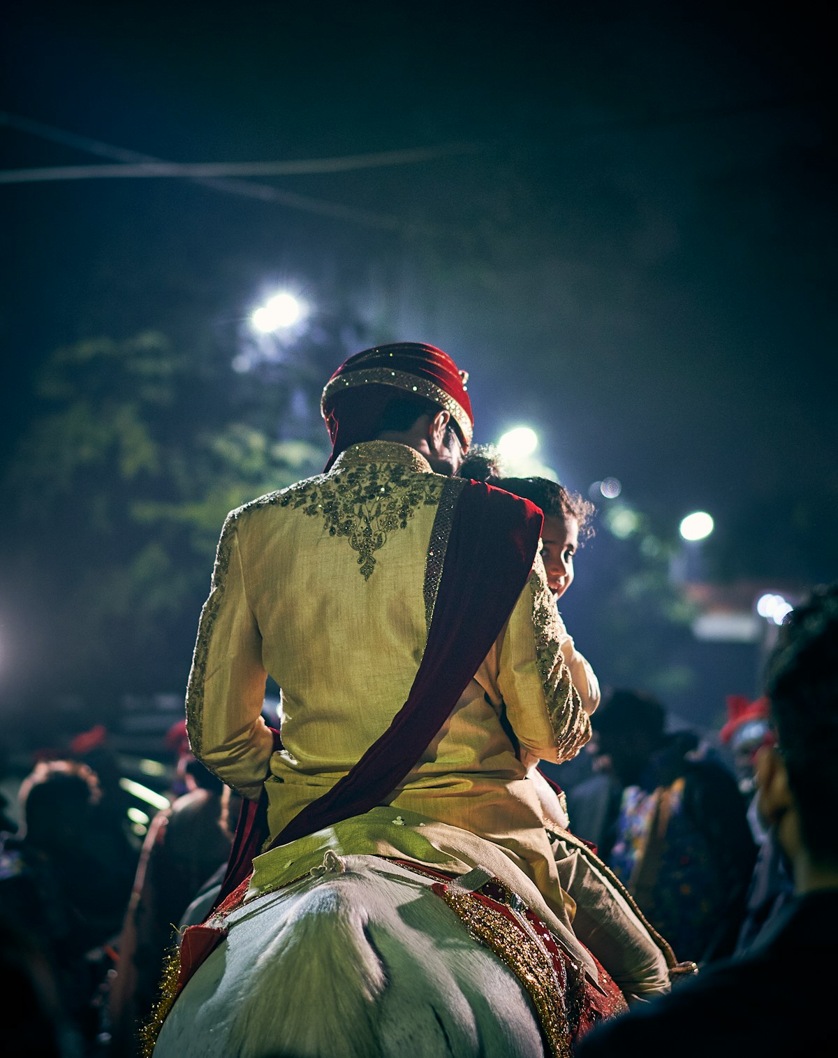 Groom on decorated horse with procession